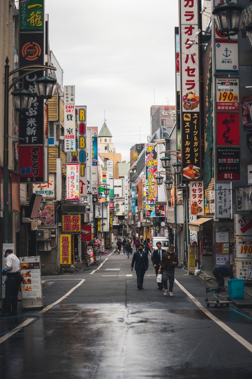 Free Vibrant Shinjuku streetscape in Tokyo, bustling with people and colorful signs. Stock Photo