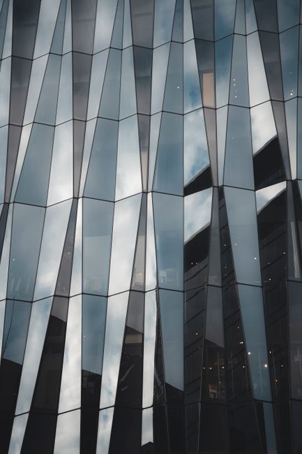 Stylish glass facade in Shinjuku City, Tokyo reflecting the sky.