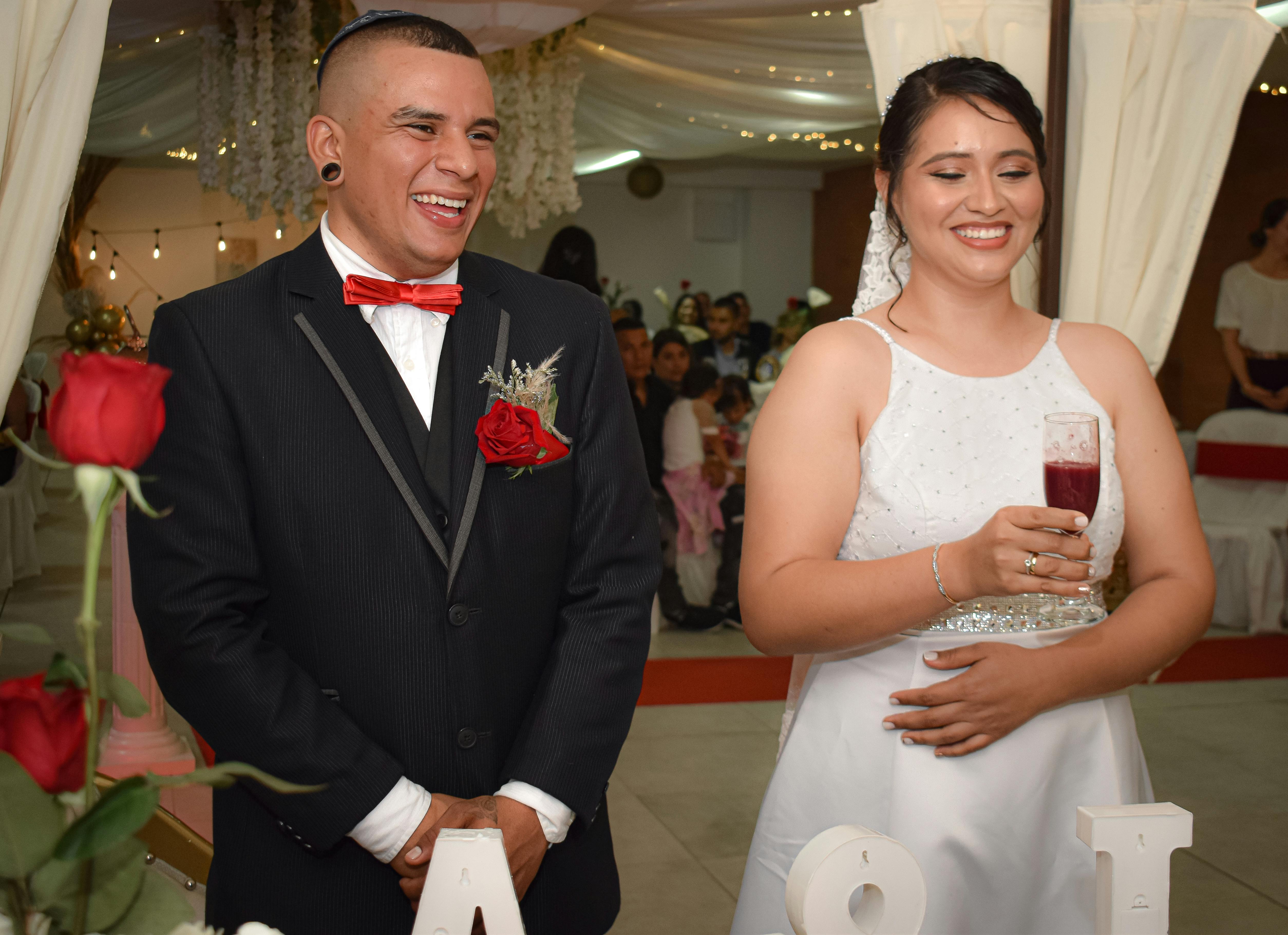 Latin Wedding Music: Cumbia, Salsa, Reggaeton & More - Smiling bride and groom at an elegant indoor wedding ceremony in Pereira, Colombia.