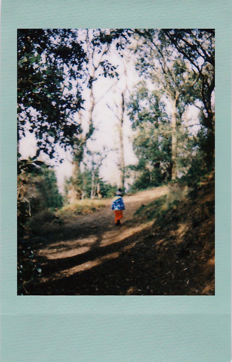 Polaroid Photo Of A Child Standing In The Country Road 