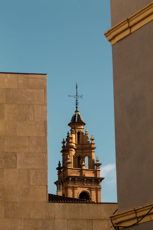 Free A historic bell tower peeks through modern architecture in Valencia, capturing a blend of old and new. Stock Photo