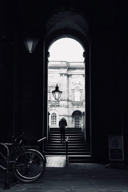 Gothic architecture with bicycle and lone figure in Edinburgh.