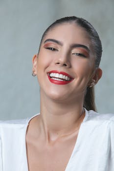 Studio portrait of a young woman with red lipstick, exuding elegance and joy.