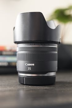 Detailed shot of a Canon 35mm lens with a hood, perfect for photography.