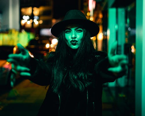 Woman in Hat at Night