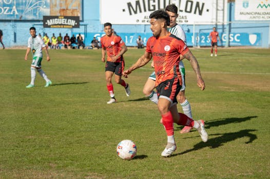 Exciting soccer match showcasing energetic players in vibrant jerseys at Mendoza's Club Social stadium.