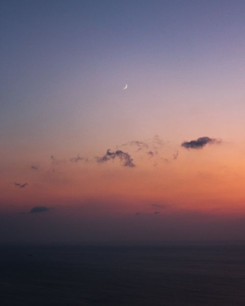Free Tranquil sunset over the sea in Istanbul with a crescent moon and colorful sky. Stock Photo