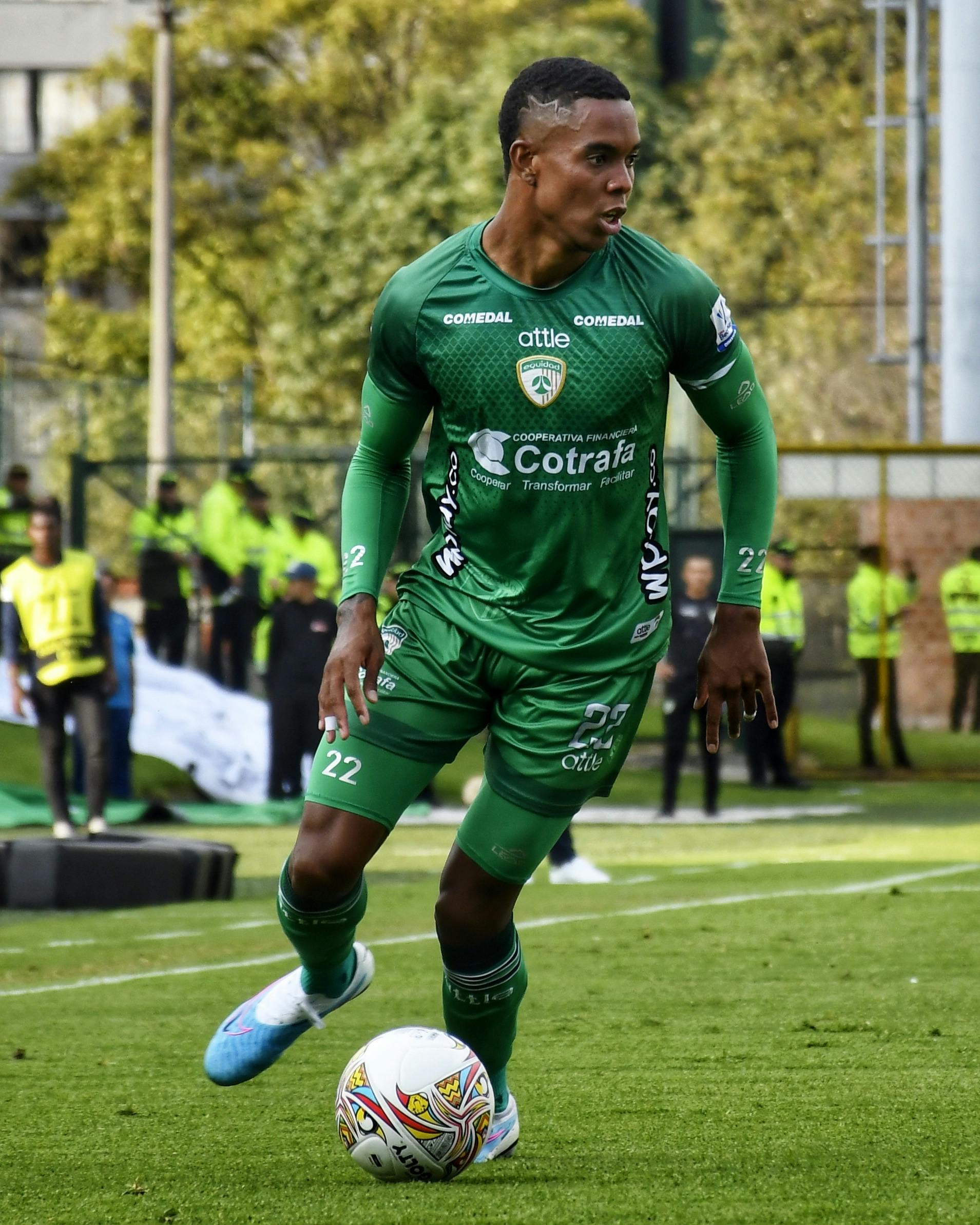 Focused soccer player in action on field, showcasing athletic prowess.