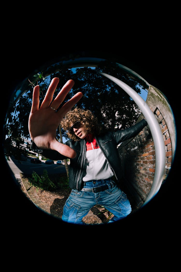 Man Stretching Hand Through Fisheye Lens