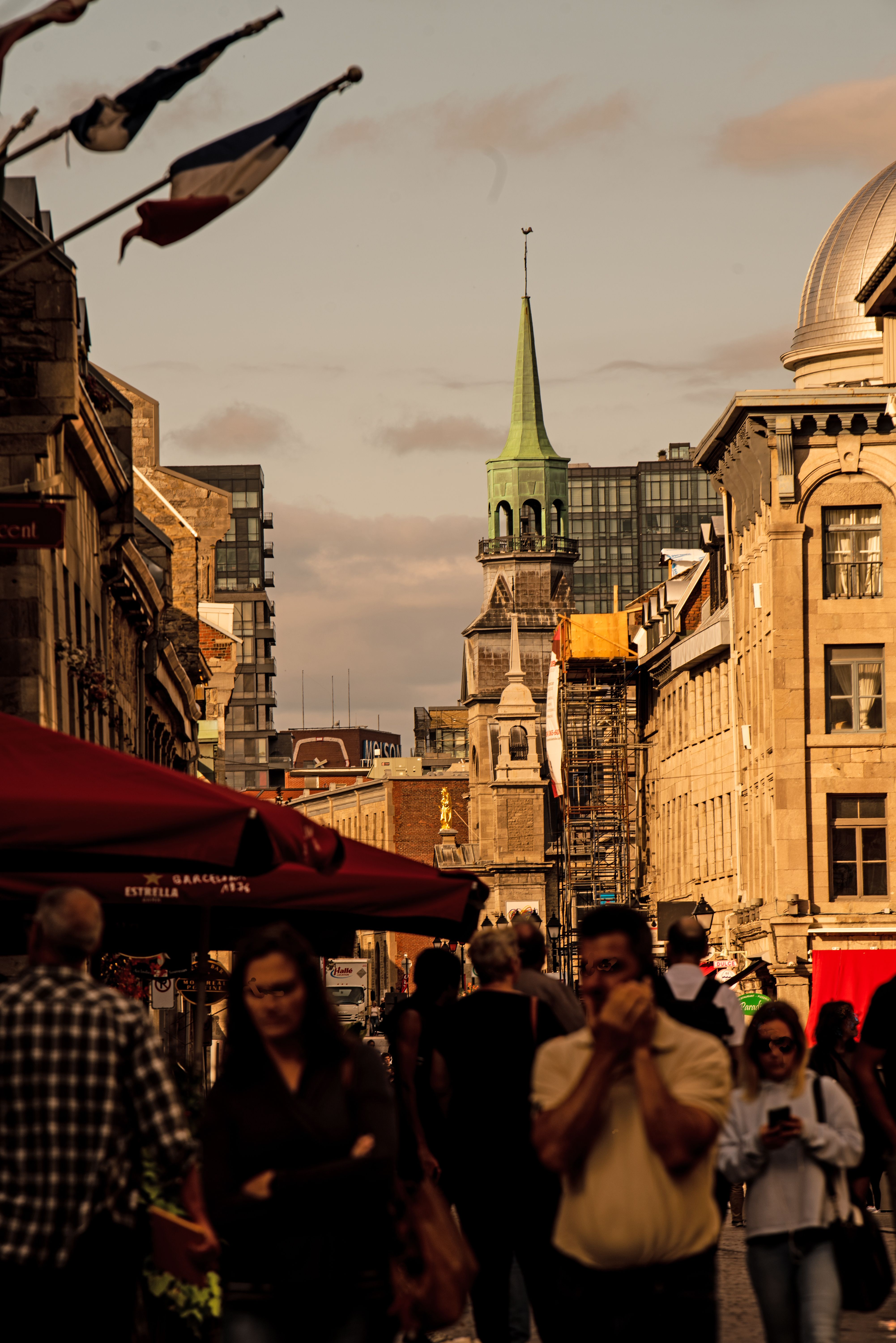Lively pedestrian street between traditional stone buildings in Old Montreal
