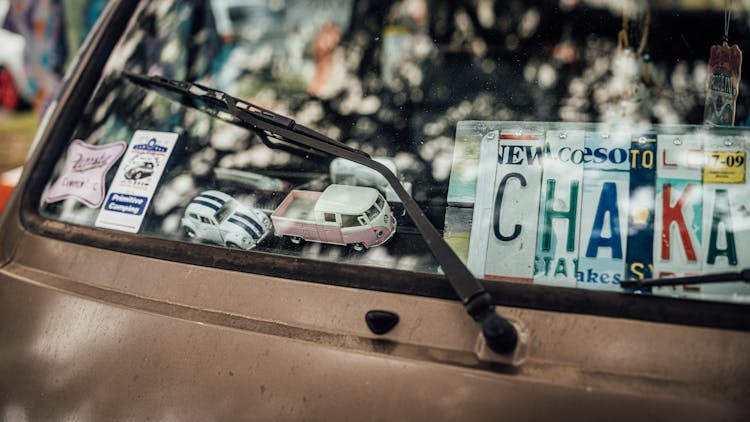 Toy Cars And Stickers On Vehicle Window