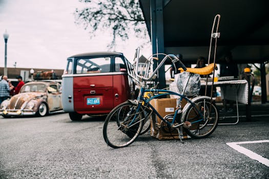 A retro bicycle parked near vintage cars in an urban area, showcasing vintage transportation.