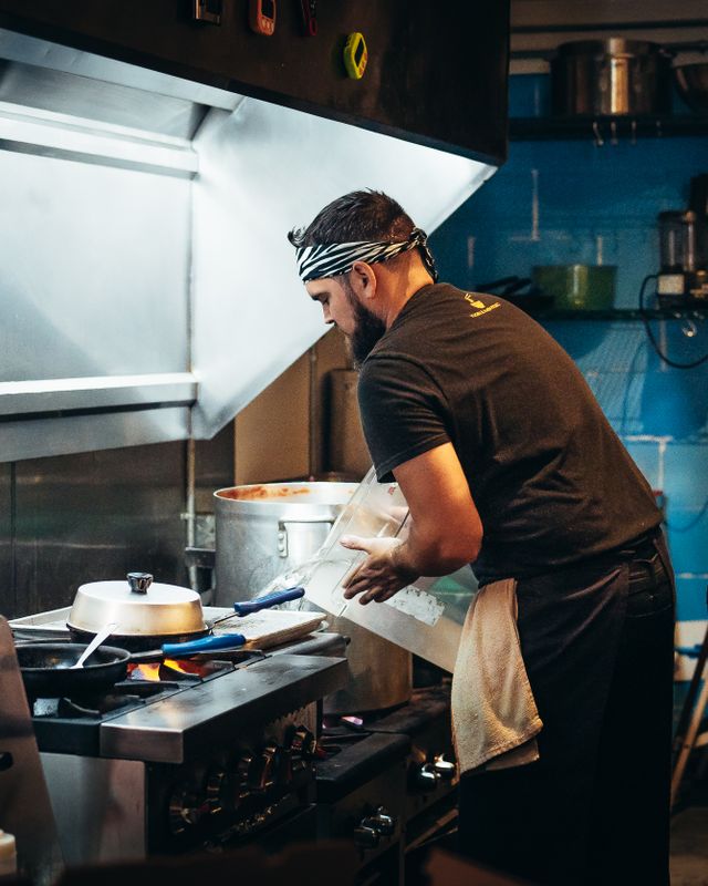 Two chefs cooking during a busy restaurant service
