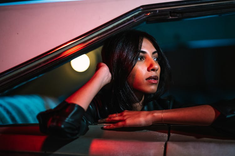 Young Woman Looking Out Of Car Window