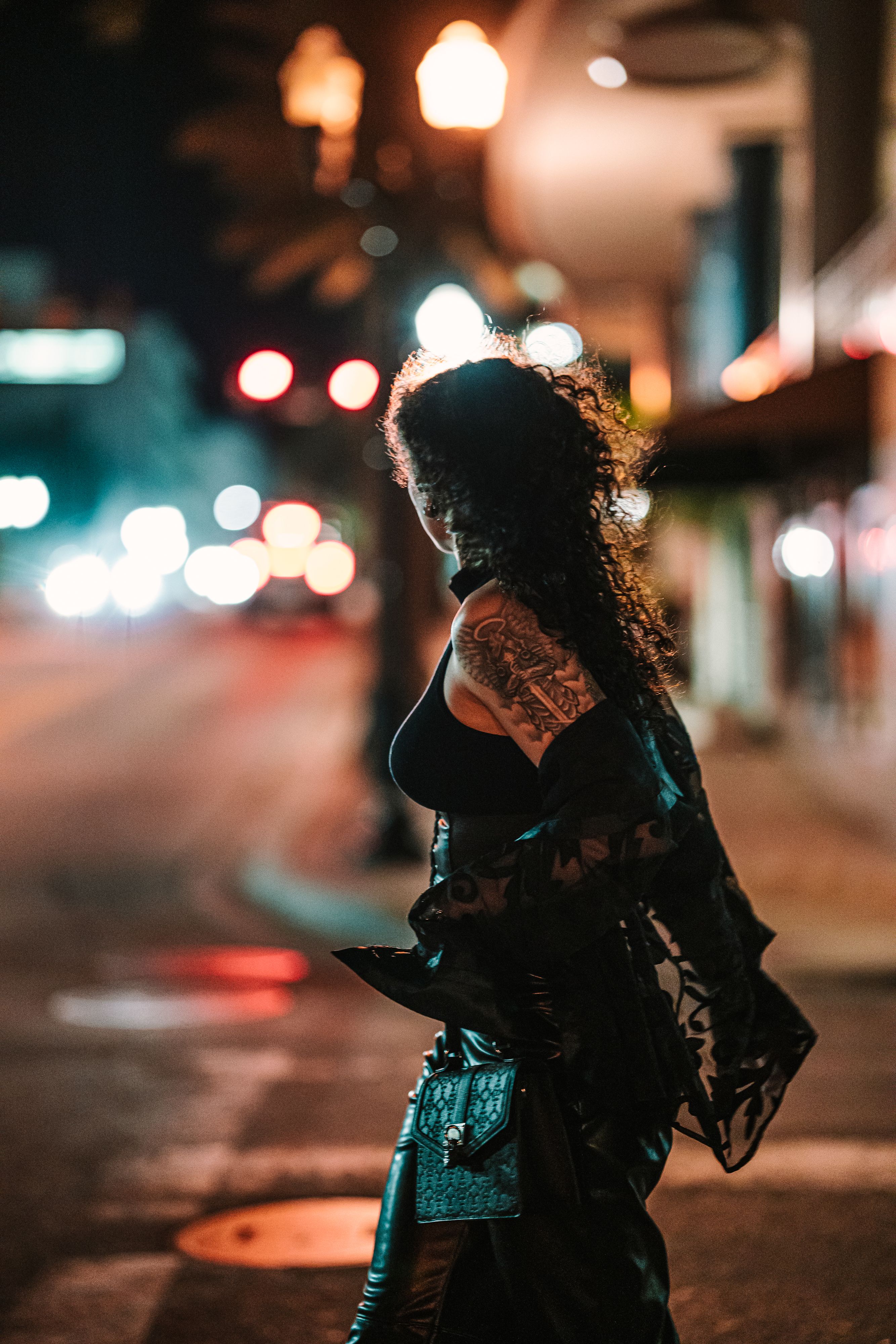 A Fashionable Woman on a Sidewalk in City at Night · Free Stock Photo