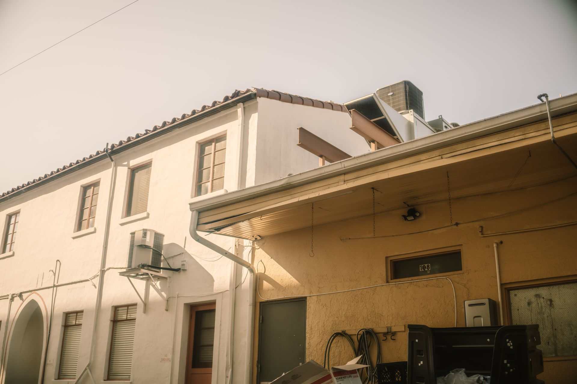 A traditional Spanish-style residential building facade in urban setting, capturing architectural details.