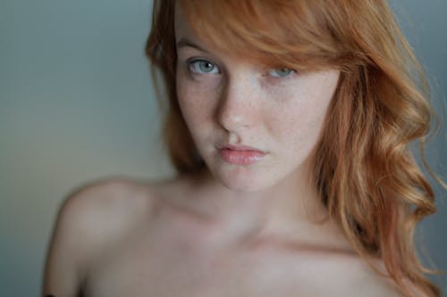 Portrait of Topless Redhead Woman Posing in Studio