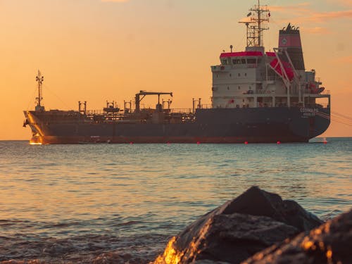View of a Large Tanker on the Sea near a Shore at Sunset