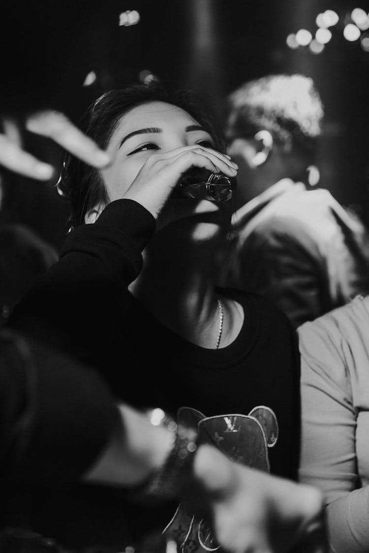 Woman Drinking Shot In Bar