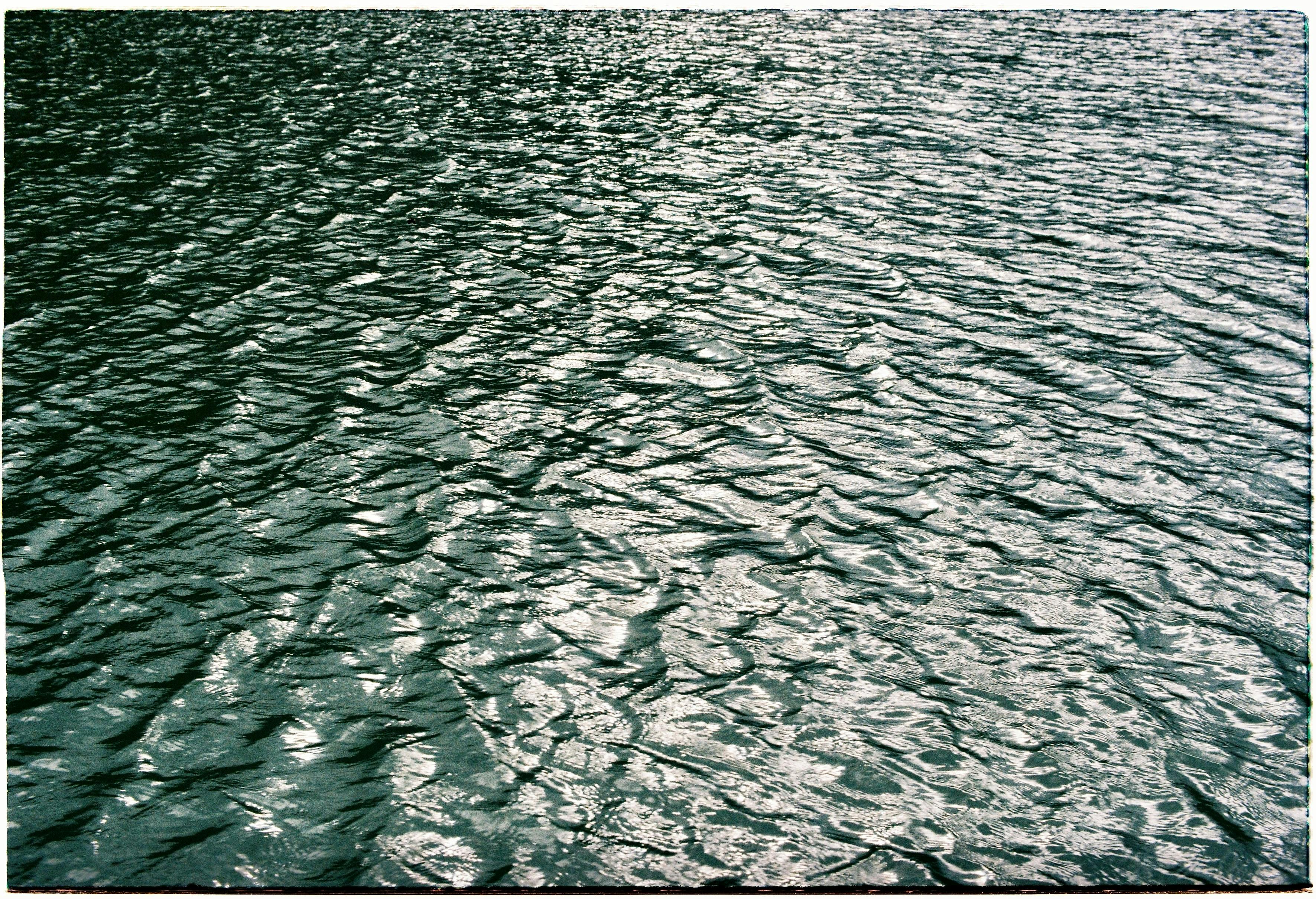 Calm rippling water reflecting light in Dalat, Vietnam, showcasing serene natural beauty.