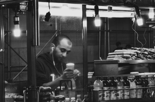 Free Capturing a New York City street vendor serving food at night. Stock Photo