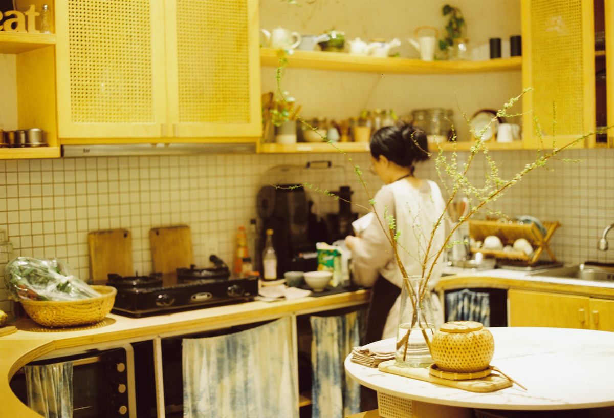 Cook preparing food in a warm kitchen — photo by Nam Quan Nguyen on Pexels