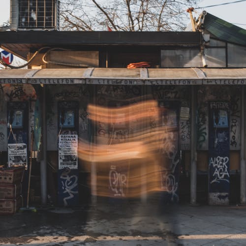 Blurred Walking Person near Abandoned Building