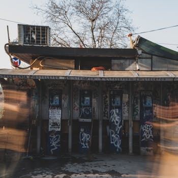 Rustic phone booths with graffiti in an urban setting showing urban decay.
