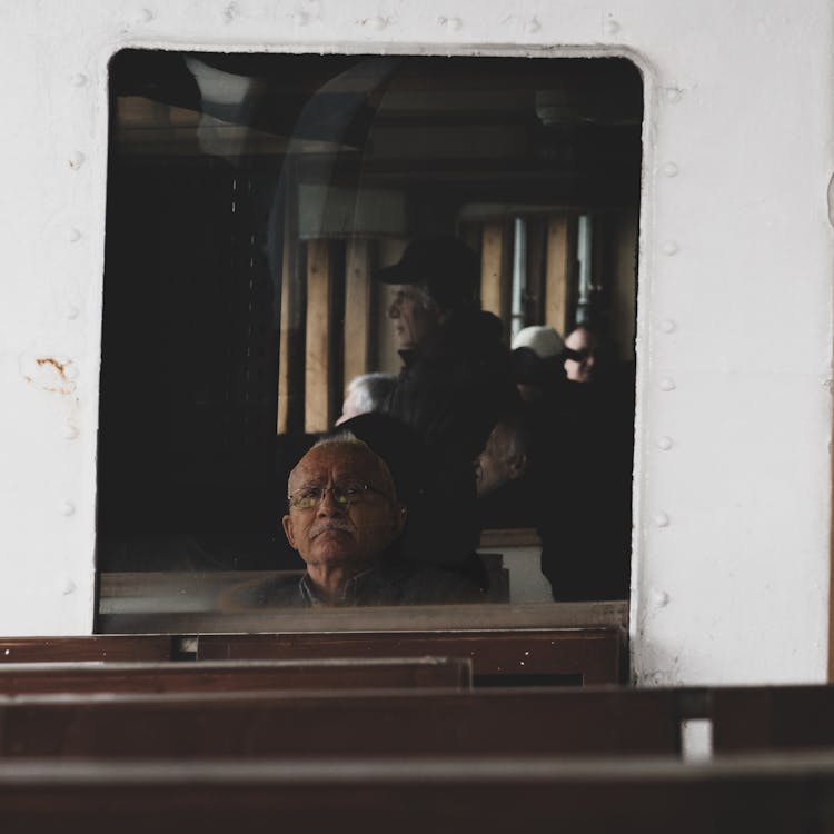 Old Man In Train Reflection In Mirror