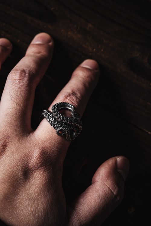 Free Closeup of a hand wearing an oxidized silver octopus ring with detailed tentacles. Stock Photo