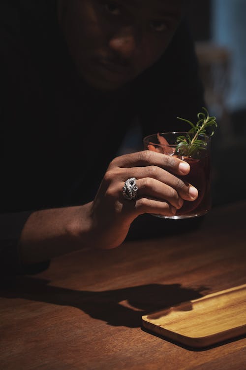 Man with Silver Ring Holding a Drink 