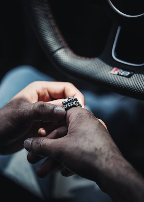 Man with a Silver Ring Sitting in a Car 