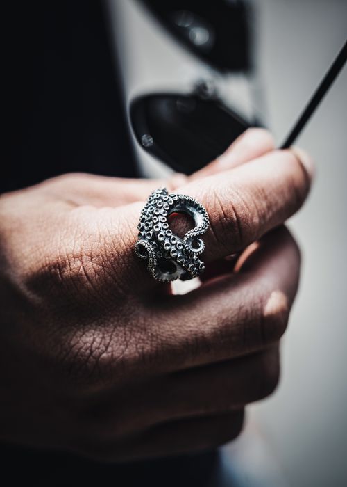 Free Artistic close-up of a hand wearing an octopus-shaped metal ring, showcasing craftsmanship. Stock Photo