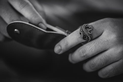 Man with an Octopus Ring Holding a Knife in Black and White 