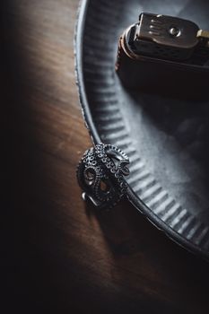 Stylish silver octopus ring showcased on a textured metal tray with a moody atmosphere.