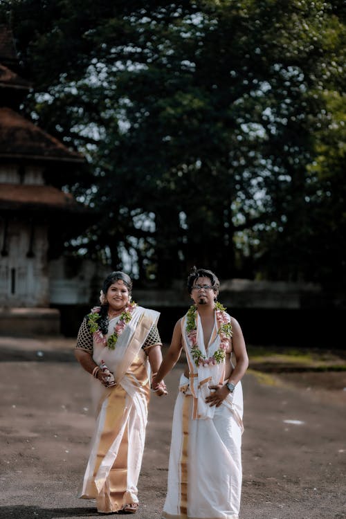 Couple Walking and Posing in Traditional Clothing