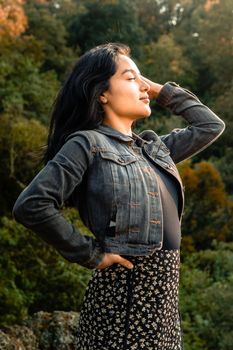 A serene outdoor portrait of a woman embracing autumn's beauty in Lerma de Villada, Mexico.