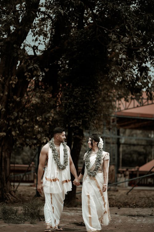 Couple Holding Hands and Walking