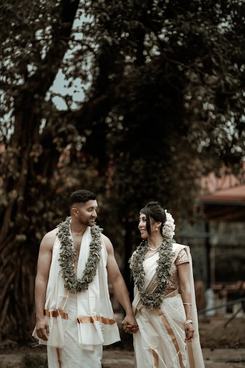 Couple in Traditional Clothing with Garlands