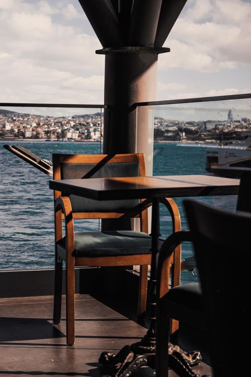 Free Empty café table on a balcony with view of the Bosphorus and Istanbul skyline. Stock Photo
