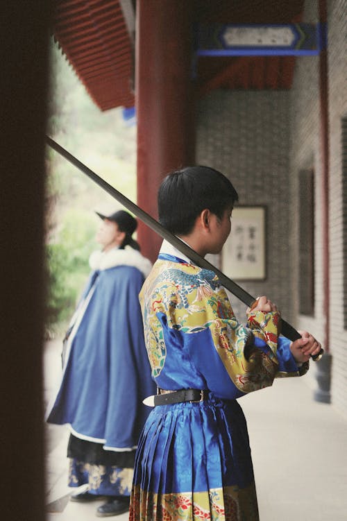 Boy in Traditional Clothing and with Sword