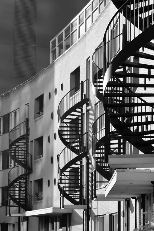 Free Black and white photo of spiral staircases on a modern building in Tilburg, Netherlands. Stock Photo