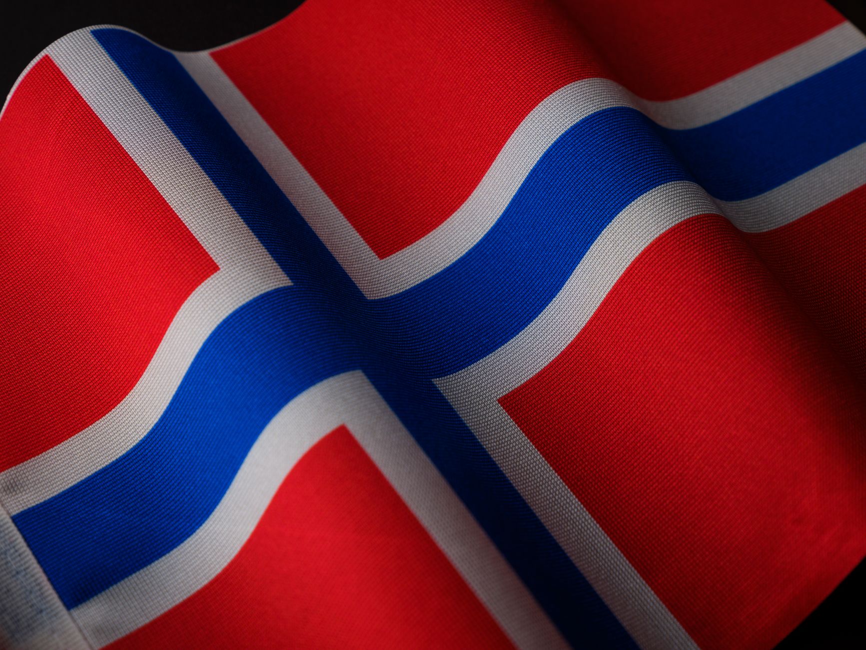 Norwegian supporters waving red blue flags outside a stadium before a World Cup match