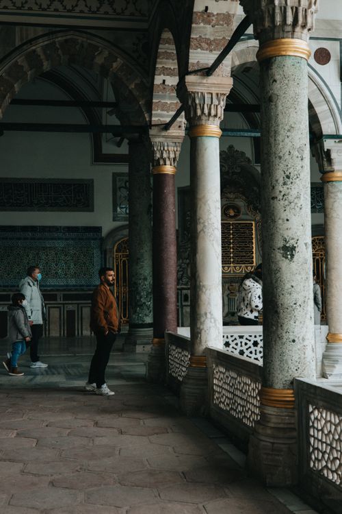 Free Indoor view of a historic palace with columns and visitors in Türkiye, showcasing ornate architecture. Stock Photo