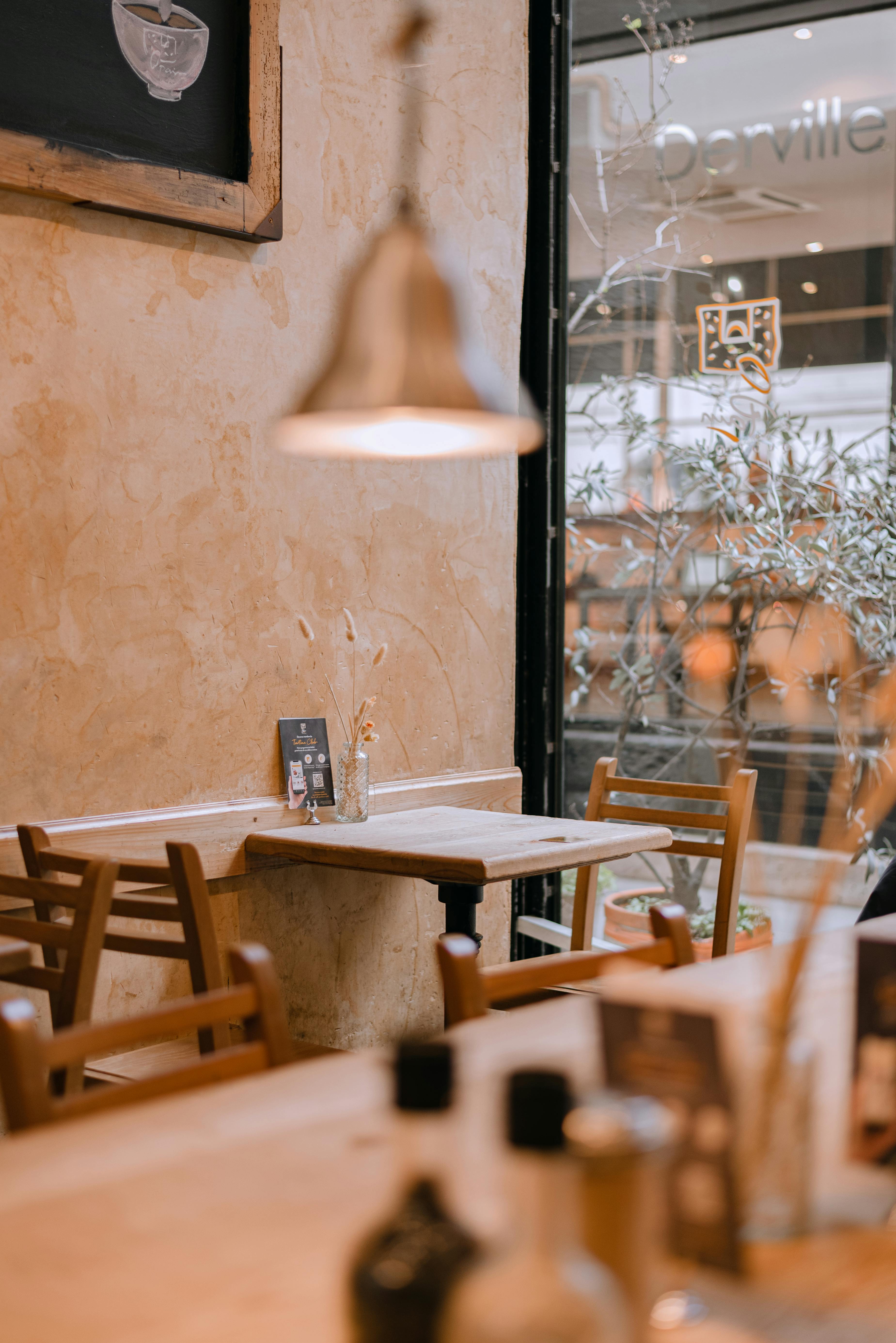 a restaurant with wooden tables and chairs