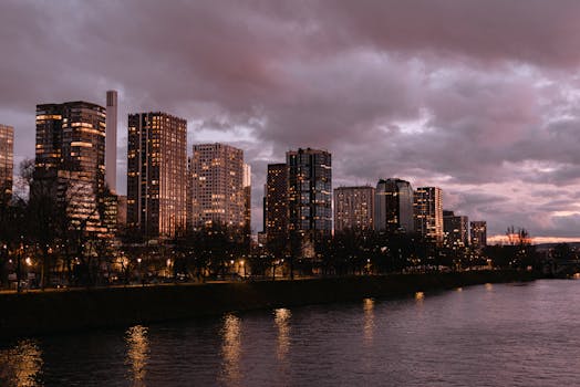 Parisian skyscrapers reflecting on the Seine River at dusk, capturing urban beauty and vibrant city life.