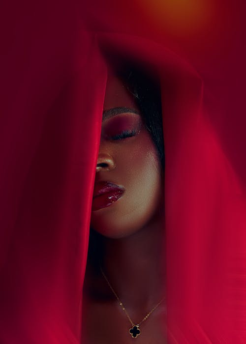 Close-up of Woman with Makeup in Red Fabric