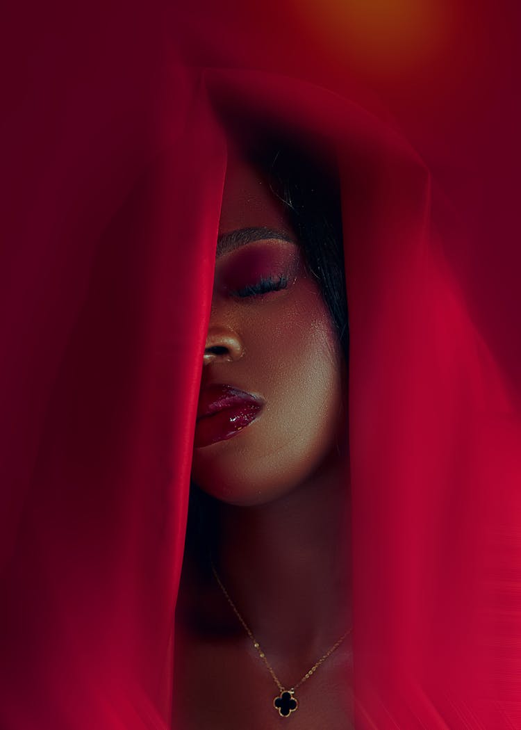 Close-up Of Woman With Makeup In Red Fabric