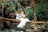 Two People Sitting on Log