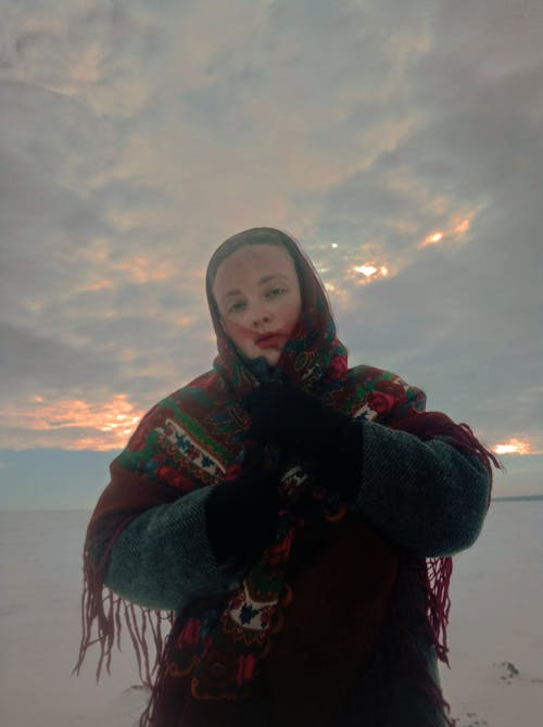 Free Woman Posing in Shawl under Clouds Stock Photo